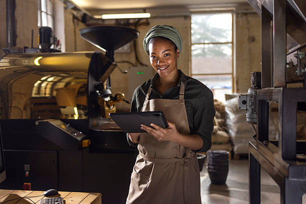 istock Young Coffee Roaster Managing Production with Tablet in Cozy Workshop 2238334133