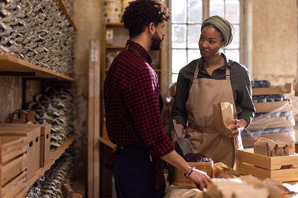 istock Two Workers in a Rustic Warehouse Discussing Bags of Coffee, Building Teamwork and Trade 2238334184