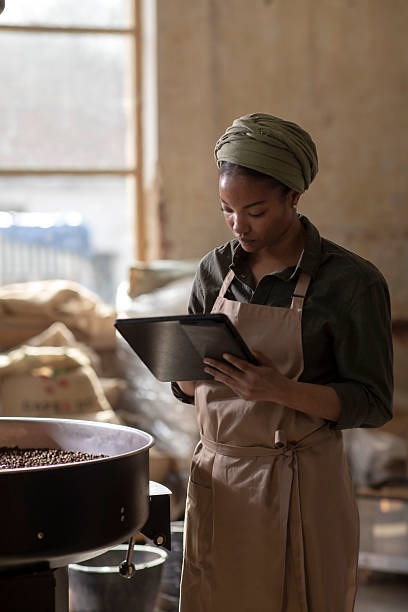 istock Coffee Roaster Operating in Industrial Workspace Using Digital Tablet for Productivity 2238334467
