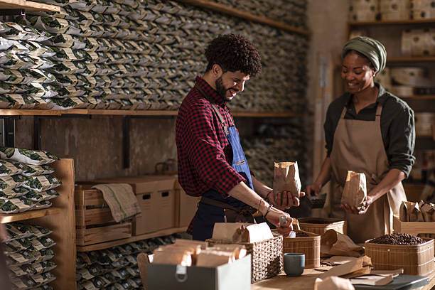 istock Two Coffee Shop Workers Packaging Products in a Cozy Store Setting 2238334495