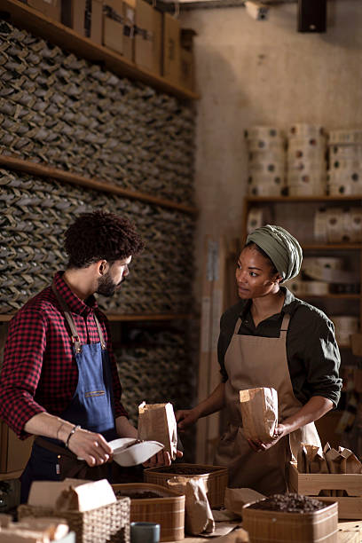 istock Two Workers Preparing Coffee Bags in a Cozy Artisan Workshop 2238334496