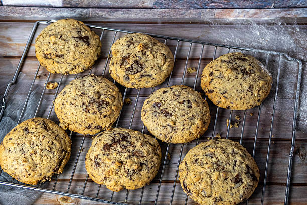 A rack of cookies with chocolate chips and nuts