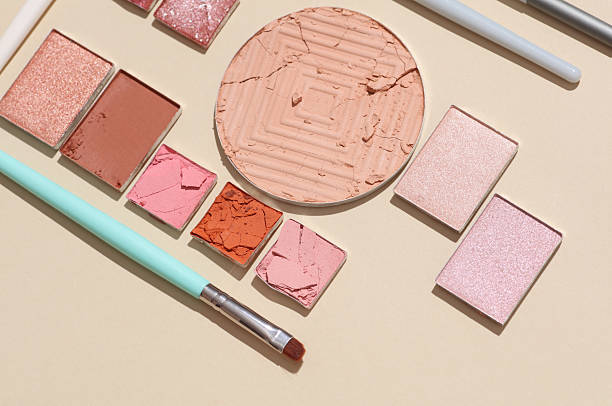 istock Crushed eyeshadow for makeup with brushes. Cosmetic product sample on beige background. Creative layout 2238337315