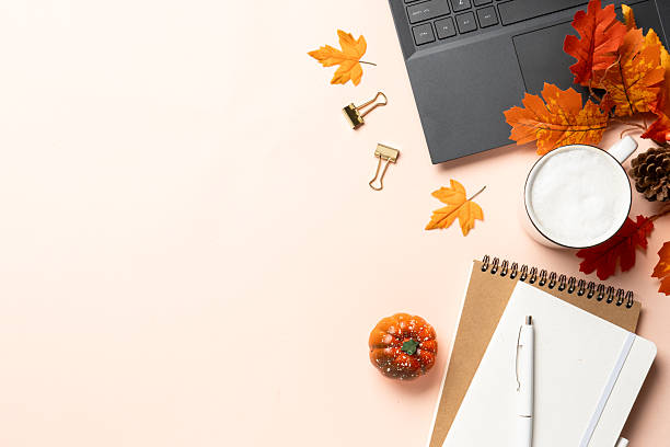 istock Autumn office desk. Laptop, notebook, coffee cup and yellow leaves. 2238338419