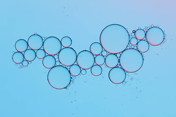 istock Oil bubbles in water on blue background, scientific abstract texture with gradient light. 2238340776