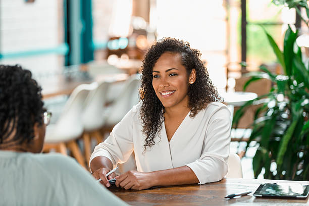 istock Two women engaged in a positive and collaborative conversation at a table. 2238342750