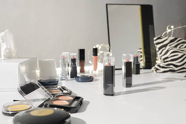 istock Makeup station at the beauty store. Cosmetics for testing. Lipsticks, blushes, poweder foundations, mirror on white makeup counter 2238345044
