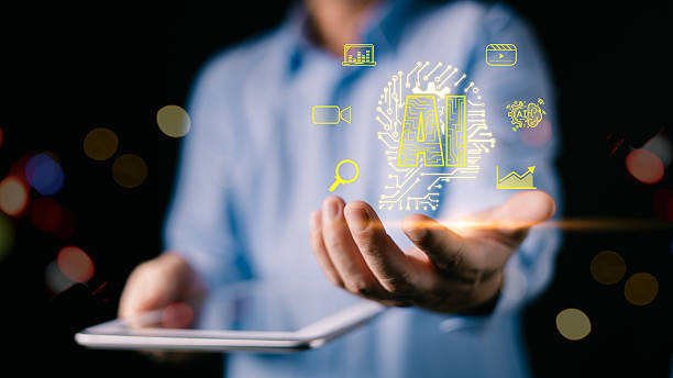 istock A man in a blue shirt holds a tablet while projecting glowing yellow AI icons, symbolizing digital innovation, data analysis, and futuristic technology.A dark bokeh background enhances contrast. 2238346511
