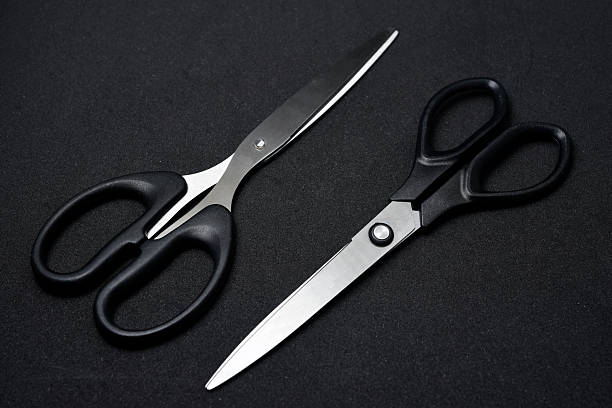 istock Two scissors on a black background. Stationery scissors. 2238348714