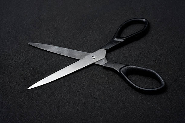 istock Two scissors on a black background. Stationery scissors. 2238348733