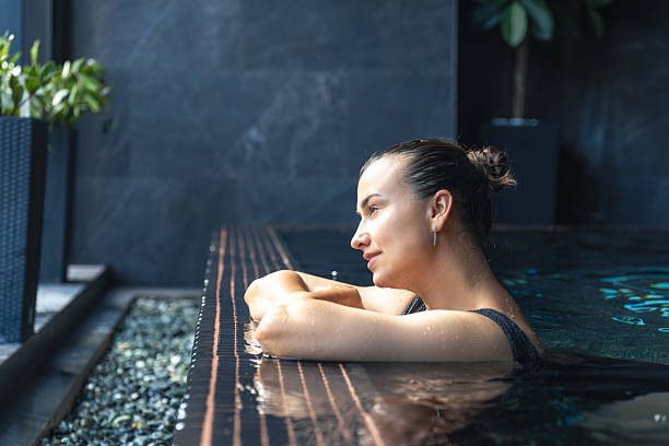 istock Woman leaning on pool edge with dreamy look. Calm pause. 2238350263