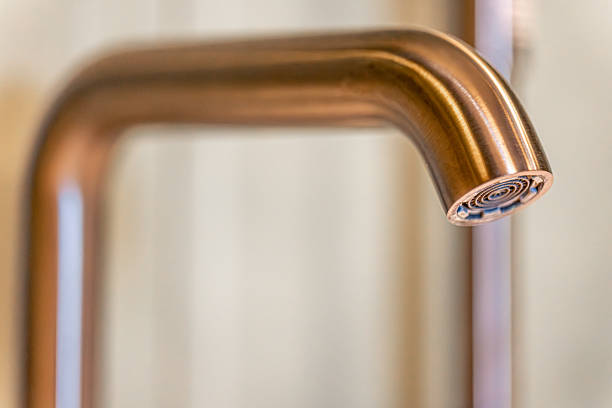 Close shot of a kitchen faucet with aerator against a neutral background. Soft reflections and fluid geometry create a clean, modern feel.