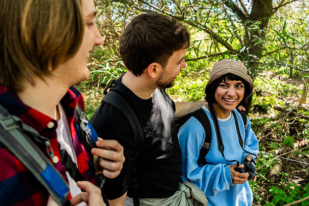 istock Young woman using camera while hiking with friends in the forest 2238352602