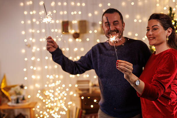 istock Couple playing with sparklers by the Christmas tree 2238354006