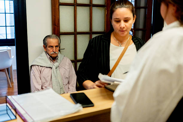 istock Mature woman talking with receptionist at lobby office 2238354055
