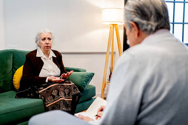 istock Senior woman talking to a psychologist during a session 2238354628