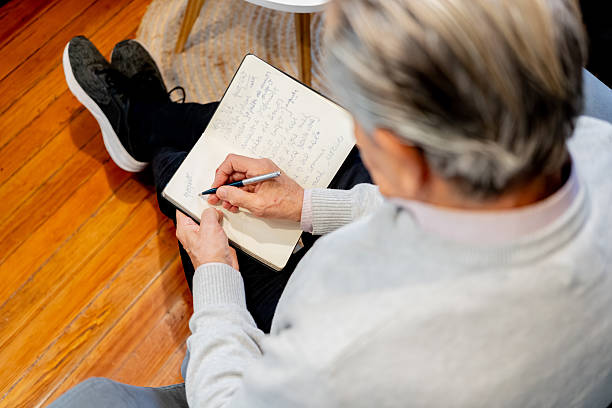 istock Close-up of a psychologist writing on notepad during therapy session 2238354654