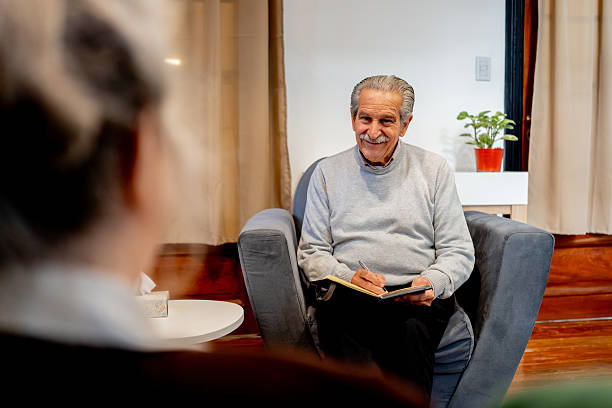 istock Senior psychologist writing on notepad during therapy session 2238354658