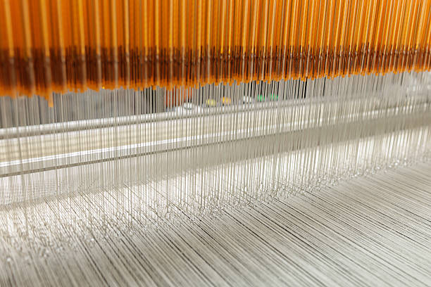 istock Jacquard loom heddles guiding warp threads in modern textile manufacturing 2238367630