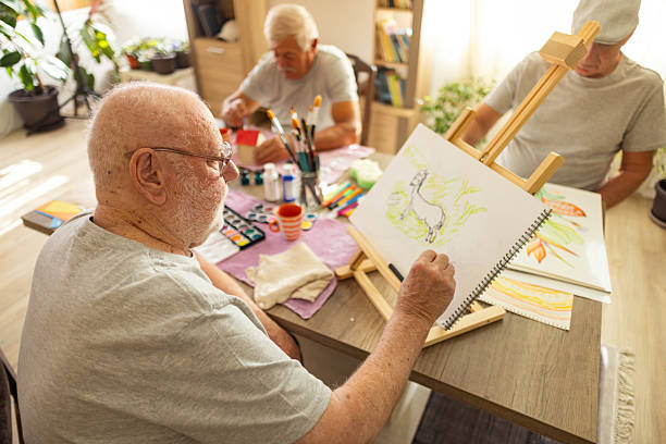 istock Elderly man painting at easel 2238370635