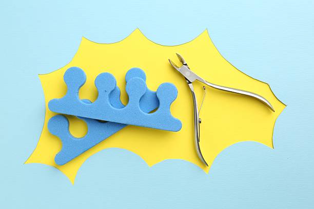istock Pedicure procedure. Nippers and toe separators on color background, flat lay 2238370821