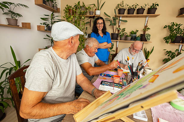 istock Seniors painting with caregiver support 2238370833