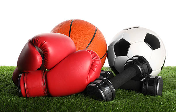 Different sport equipment on artificial grass isolated on white