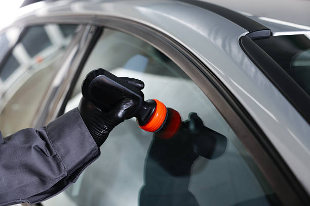 istock Man polishing car window indoors, closeup view 2238373527