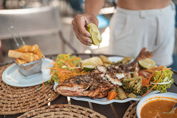 istock Hand-seasoning fish in a Brazilian restaurant 2238374859
