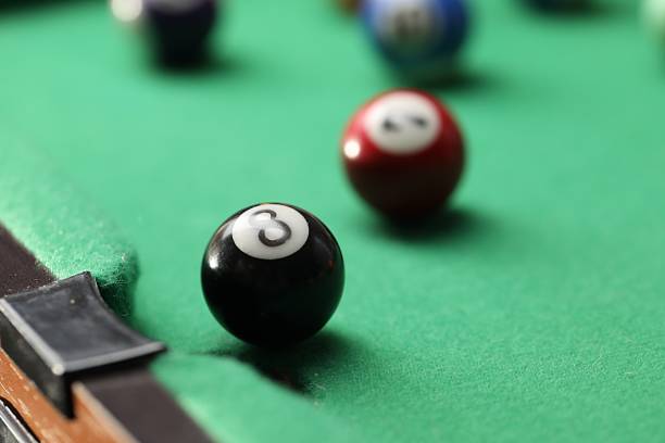 istock Billiard balls on green table, closeup view 2238375495
