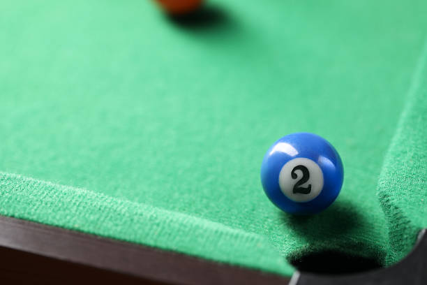 istock Billiard ball on green table, closeup. Space for text 2238375615