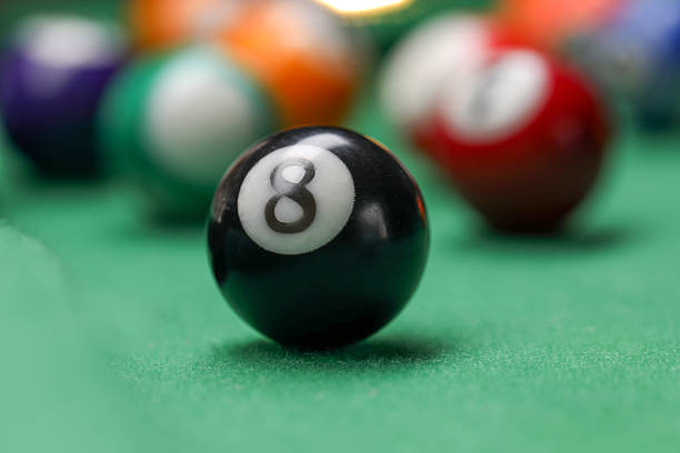 Many colorful billiard balls on green table, closeup