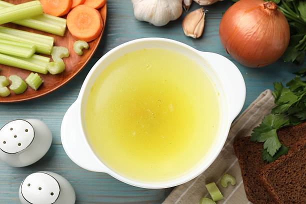 istock Tasty chicken bouillon served on light blue wooden table, flat lay 2238376003