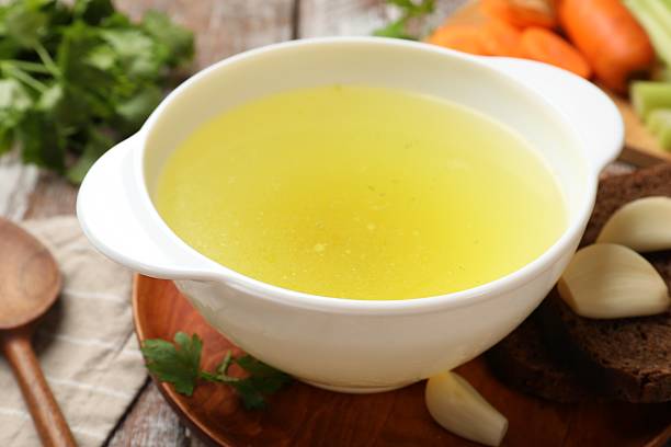istock Tasty chicken bouillon served on wooden table, closeup 2238376027