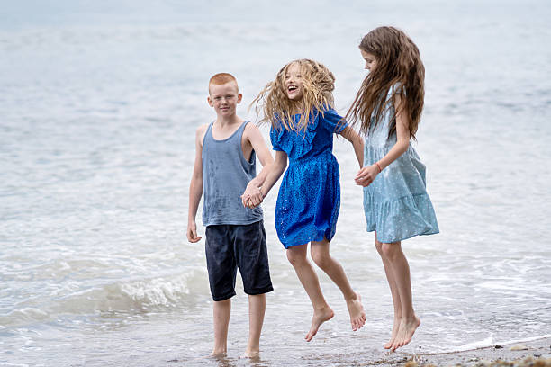 a young family walks on the seashore. parents play with their son on the seashore. vacation.