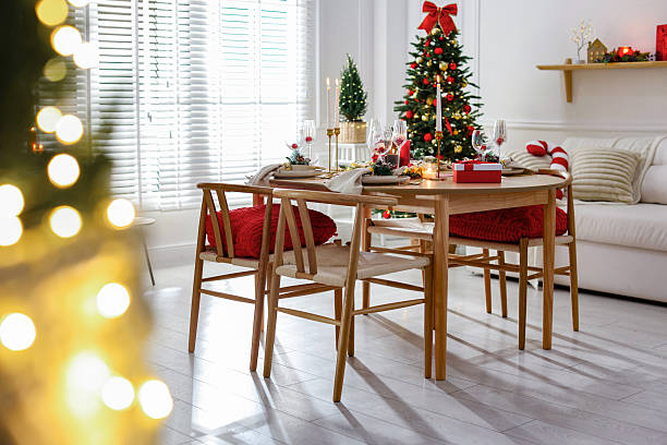 istock Christmas table setting with stylish dishware, glasses and burning candles in festive decorated room 2238378080