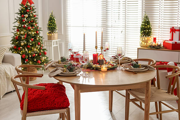 istock Christmas table setting with stylish dishware, glasses and burning candles in festive decorated room 2238378126