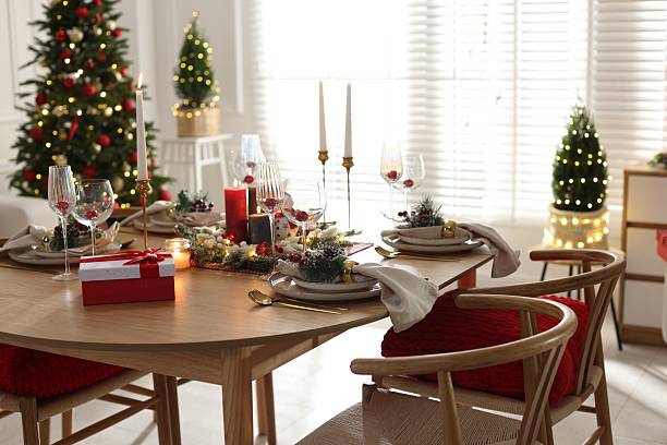 istock Christmas table setting with stylish dishware, glasses and burning candles in festive decorated room 2238378179