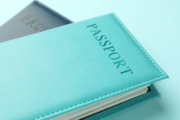istock Passports in color covers on light blue background, closeup 2238378428