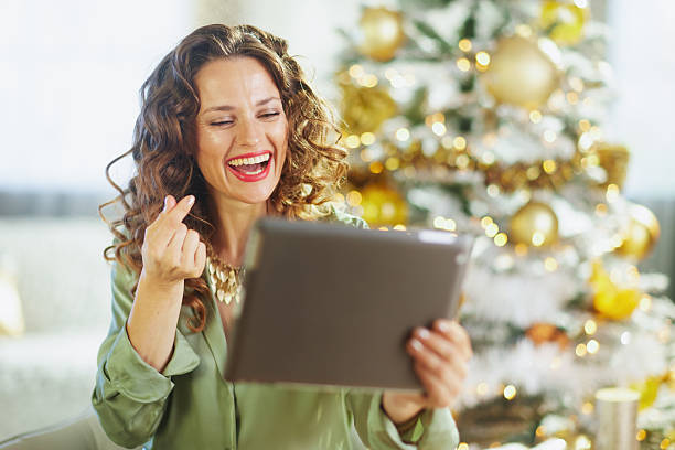 istock Woman\'s Festive Heart Gesture with Tablet 2238378758