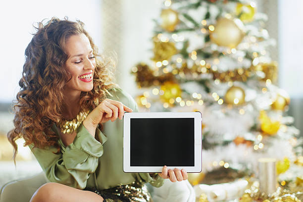 istock Festive Woman Explaining with Tablet at Christmas 2238378766