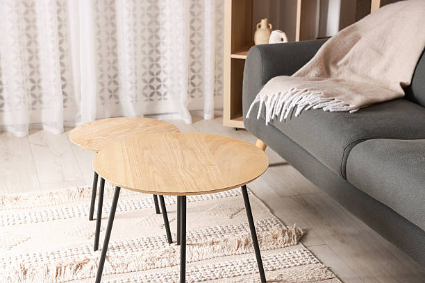 istock Stylish nesting tables near sofa at home 2238378779