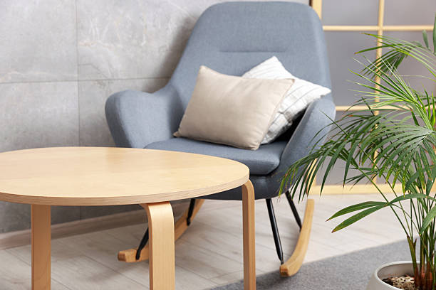 istock Stylish coffee table and rocking chair at home 2238378799