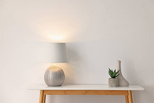 istock Stylish console table with lamp and decor near white wall indoors. Space for text 2238379655