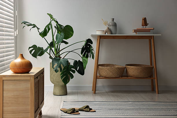 Stylish room interior with console table near white wall