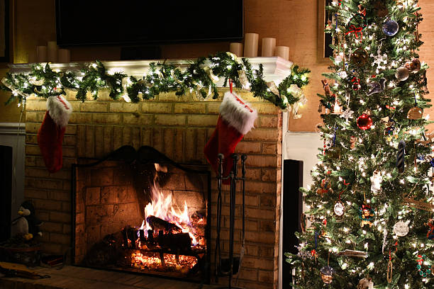 Christmas Tree by a fireplace with decorated mantelpiece