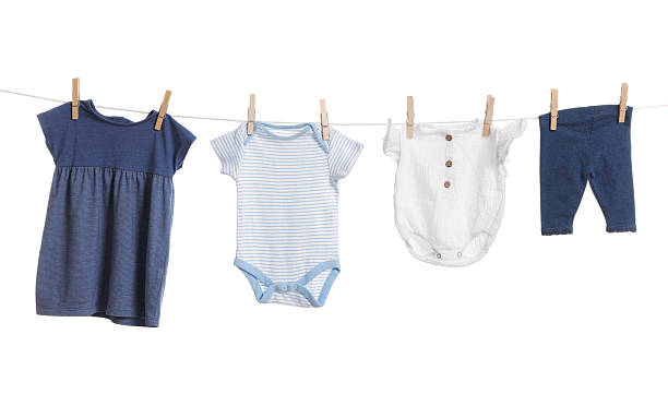 istock Different baby clothes drying on laundry line against white background 2238380539