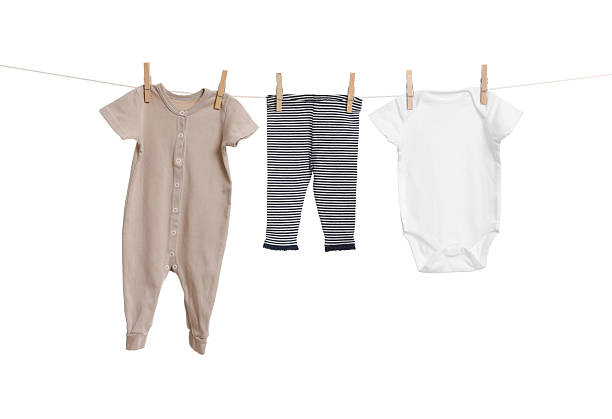 istock Different baby clothes drying on laundry line against white background 2238380606