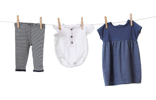 istock Different baby clothes drying on laundry line against white background 2238380655