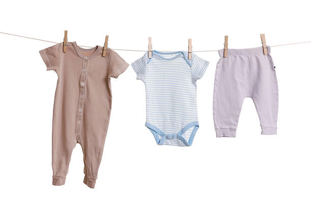istock Different baby clothes drying on laundry line against white background 2238380694